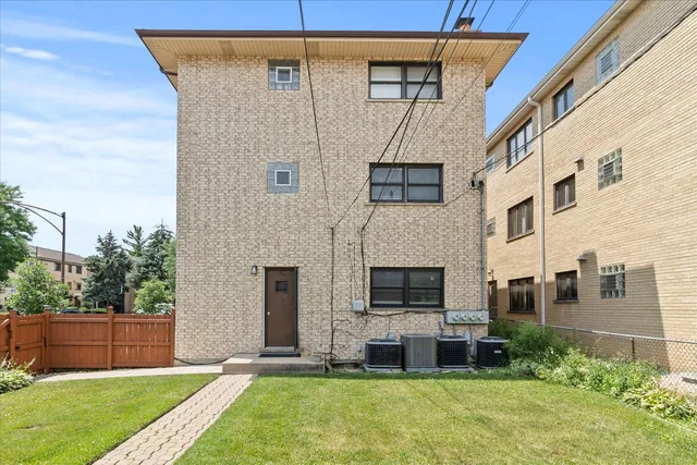 a view of an house with backyard space and a garden