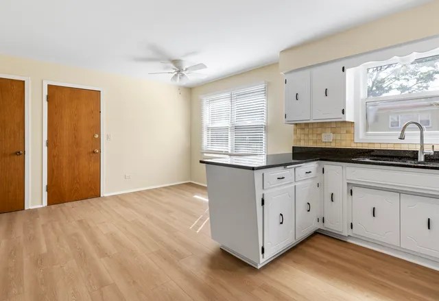a kitchen with stainless steel appliances granite countertop a sink a cabinets and window