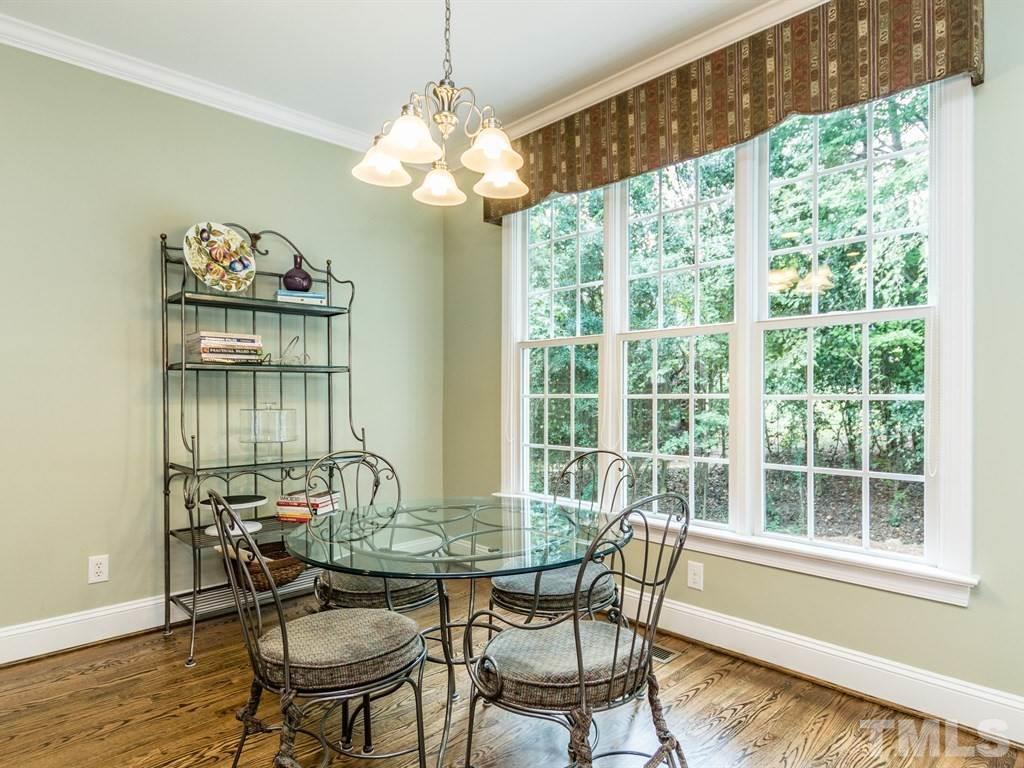 6304 Pleasant Creek Court Raleigh, NC 27613 - Photo 11 of 25 a view of a dining room with furniture wooden floor and chandelier