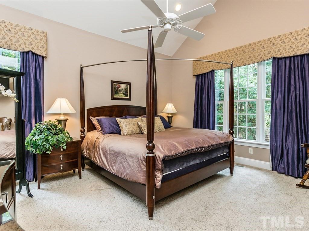 6304 Pleasant Creek Court Raleigh, NC 27613 - Photo 12 of 25 a bed sitting in a bedroom next to a window