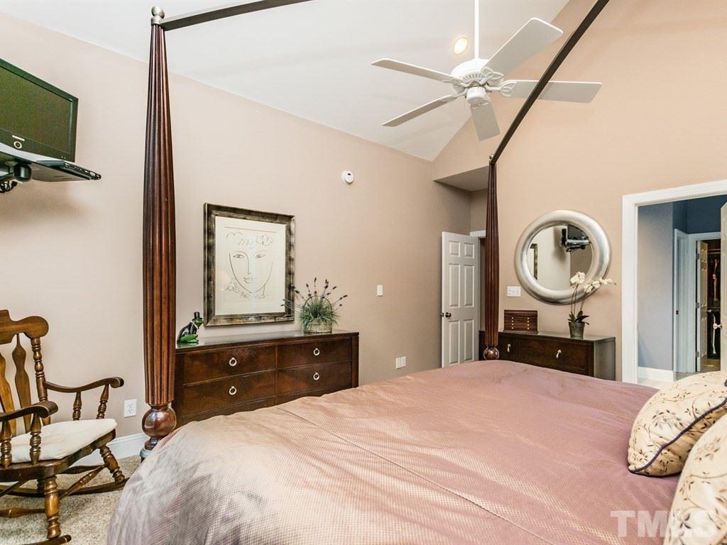 6304 Pleasant Creek Court Raleigh, NC 27613 - Photo 13 of 25 a bedroom with a bed and a chandelier
