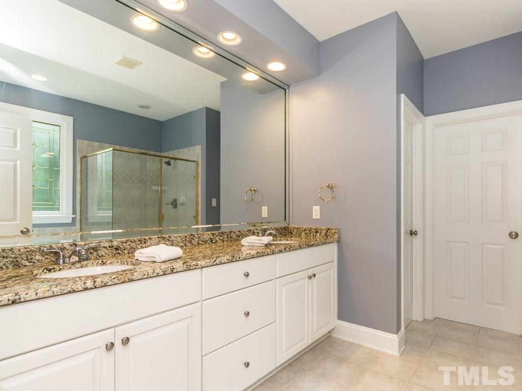 6304 Pleasant Creek Court Raleigh, NC 27613 - Photo 15 of 25 a bathroom with a granite countertop sink and a mirror