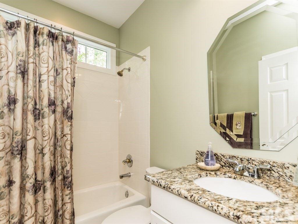 6304 Pleasant Creek Court Raleigh, NC 27613 - Photo 18 of 25 a bathroom with a granite countertop sink and a mirror