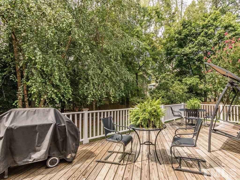 6304 Pleasant Creek Court Raleigh, NC 27613 - Photo 23 of 25 a view of backyard with seating and green space