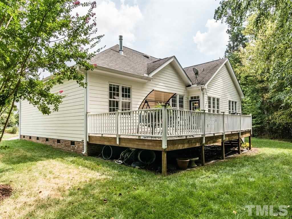 6304 Pleasant Creek Court Raleigh, NC 27613 - Photo 24 of 25 a front view of a house with a yard and deck