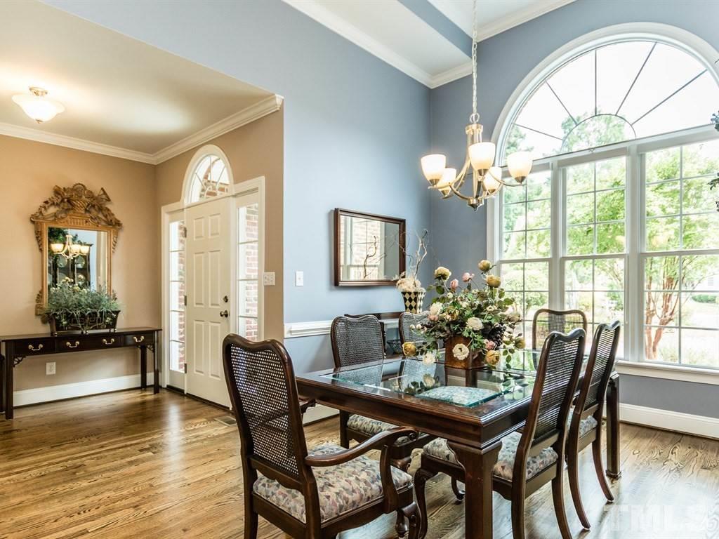 6304 Pleasant Creek Court Raleigh, NC 27613 - Photo 4 of 25 a dining room with furniture a chandelier and wooden floor