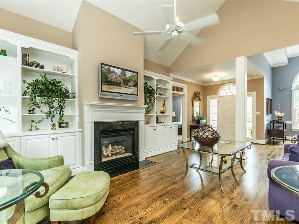 6304 Pleasant Creek Court Raleigh, NC 27613 - Photo 7 of 25 a living room with furniture a fireplace and a large window