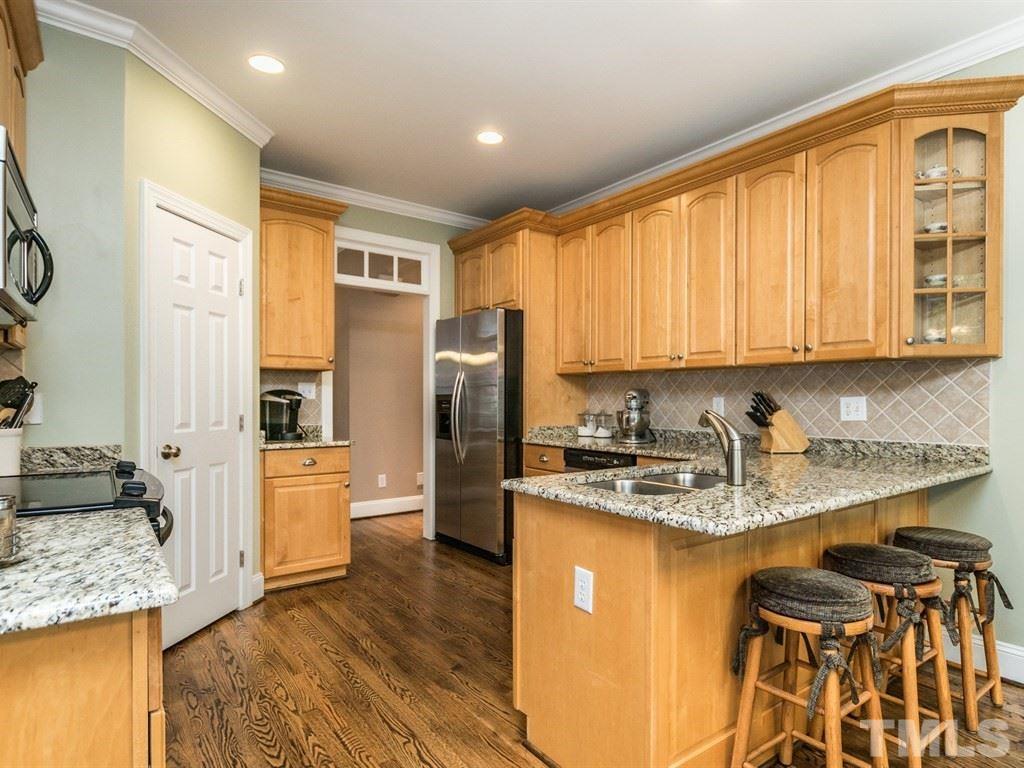6304 Pleasant Creek Court Raleigh, NC 27613 - Photo 8 of 25 a kitchen with stainless steel appliances granite countertop a sink stove refrigerator and cabinets