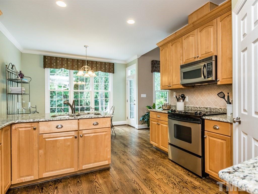 6304 Pleasant Creek Court Raleigh, NC 27613 - Photo 9 of 25 a kitchen with stainless steel appliances granite countertop a stove and a microwave