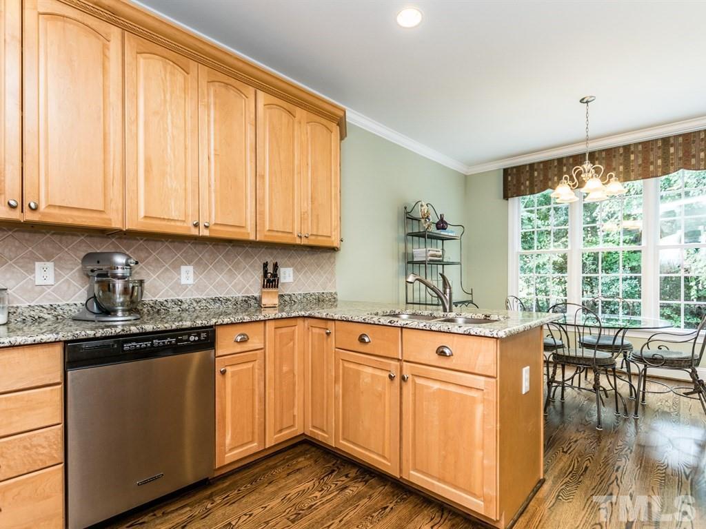 6304 Pleasant Creek Court Raleigh, NC 27613 - Photo 10 of 25 a kitchen with stainless steel appliances granite countertop a stove a sink and a microwave