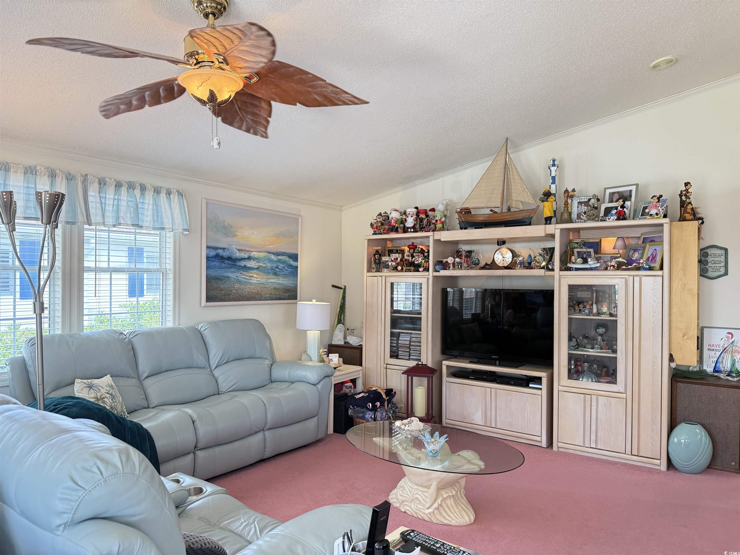 1506 Mason Circle Surfside Beach, SC 29575 - Photo 7 of 33 Living room featuring ornamental molding, carpet flooring, a ceiling fan, and a textured ceiling