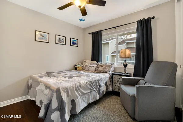 a bedroom with a bed couch and window