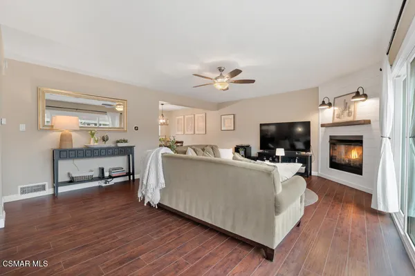 a living room with furniture a fireplace and a flat screen tv