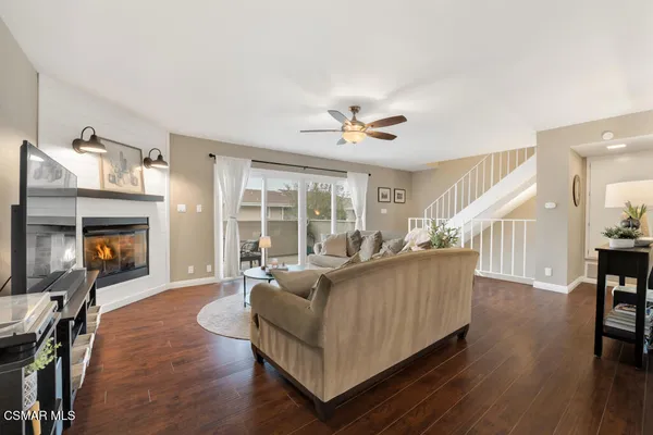 a living room with furniture and a fireplace