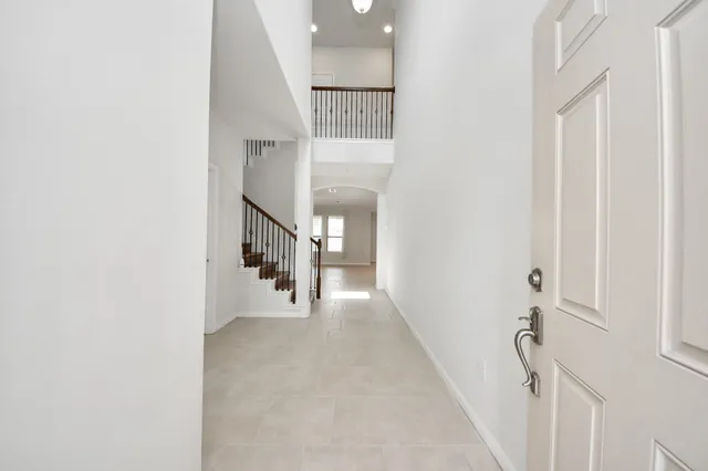 a view of a kitchen with a sink and a chandelier fan