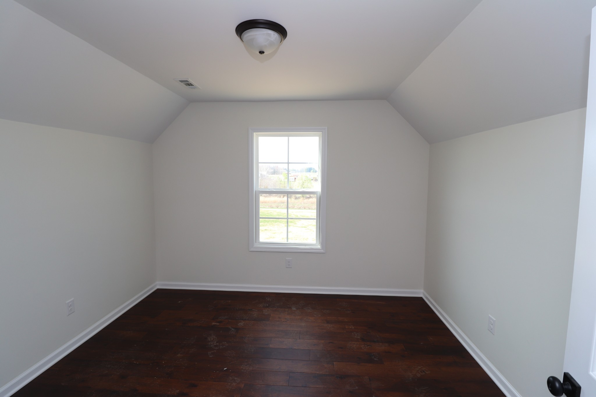 160 Garrett Road Lafayette, TN 37083 - Photo 12 of 18 an empty room with wooden floor and windows