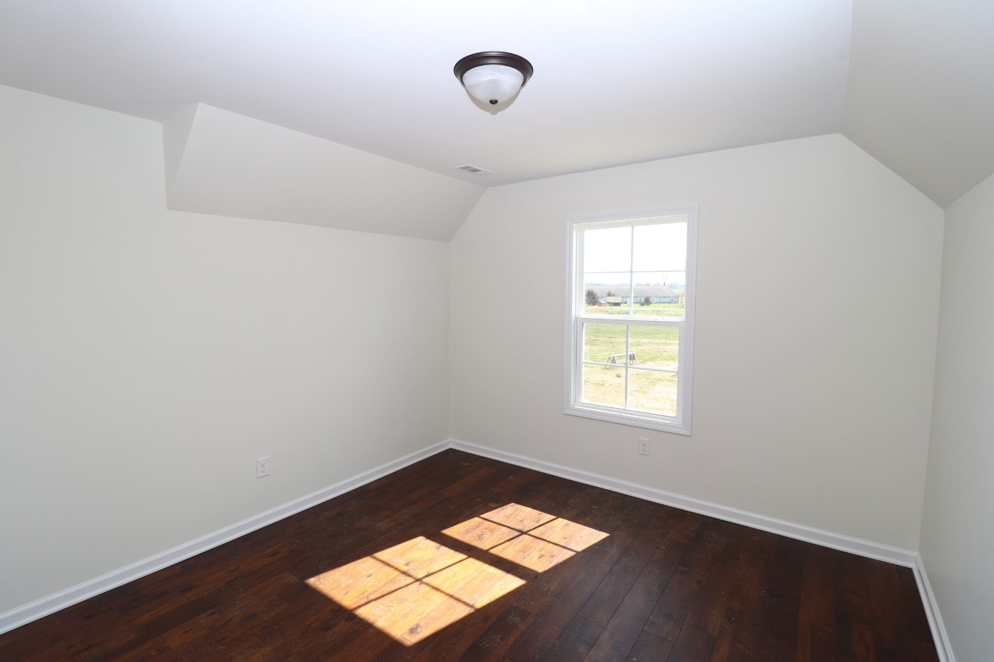 160 Garrett Road Lafayette, TN 37083 - Photo 10 of 18 an empty room with wooden floor and windows