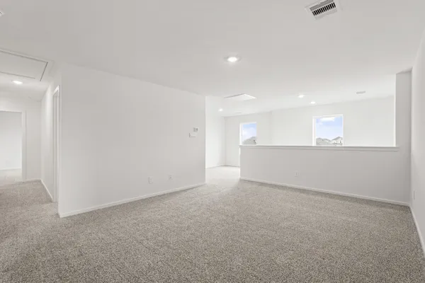 a view of an empty room with a kitchen