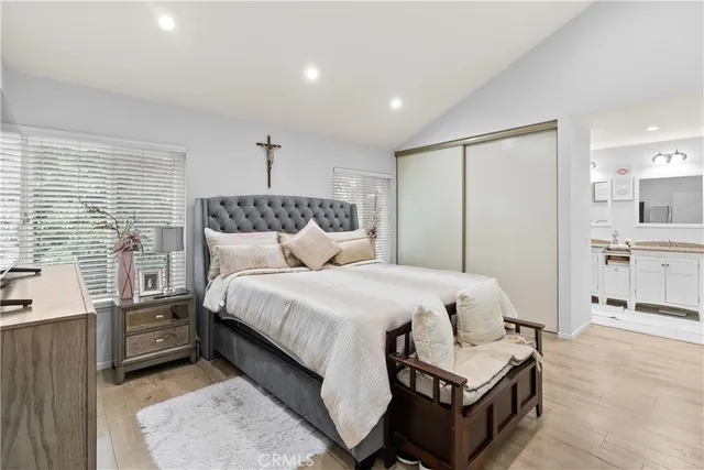 a bedroom with a bed a mirror and a dresser