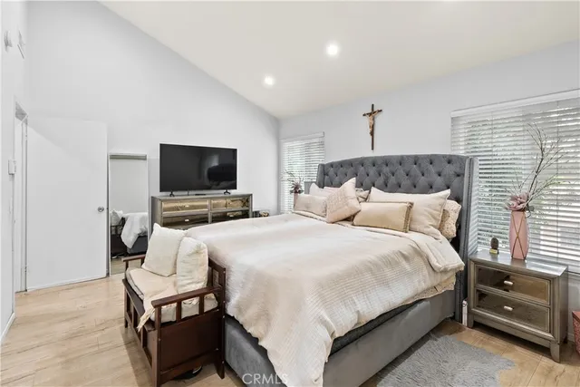 a bedroom with a bed and a flat screen tv