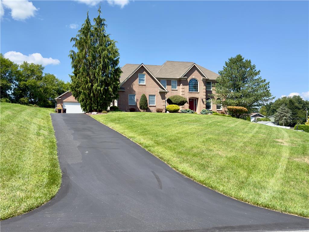 4982 Abbey Road Coplay, PA 18037 - Photo 1 of 55 An asphalt driveway leads past manicured lawns to a classic brick two-story residence.