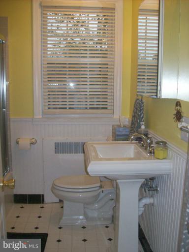 8 Murdock Road Baltimore, MD 21212 - Photo 13 of 24 a bathroom with a sink a toilet and mirror