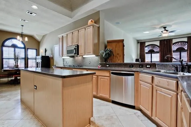 a kitchen with sink a stove and cabinets