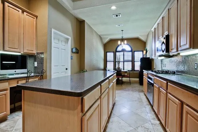 a kitchen with counter top space a sink and cabinets