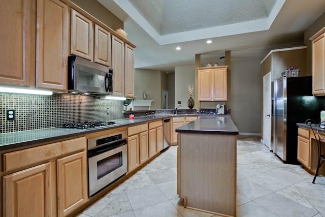 6352 Rolling Hill Road The Colony, TX 75056 - Photo 14 of 23 a kitchen with stainless steel appliances granite countertop a sink stove and refrigerator