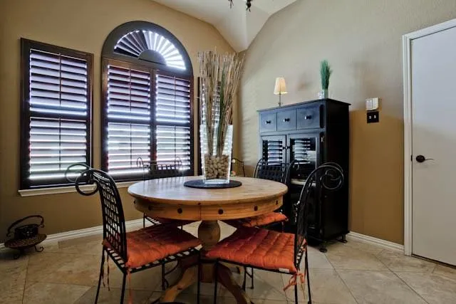 a dining room with furniture and window