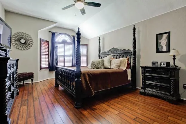 a bedroom with furniture and wooden floor