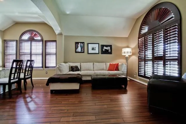 a living room with furniture and wooden floor
