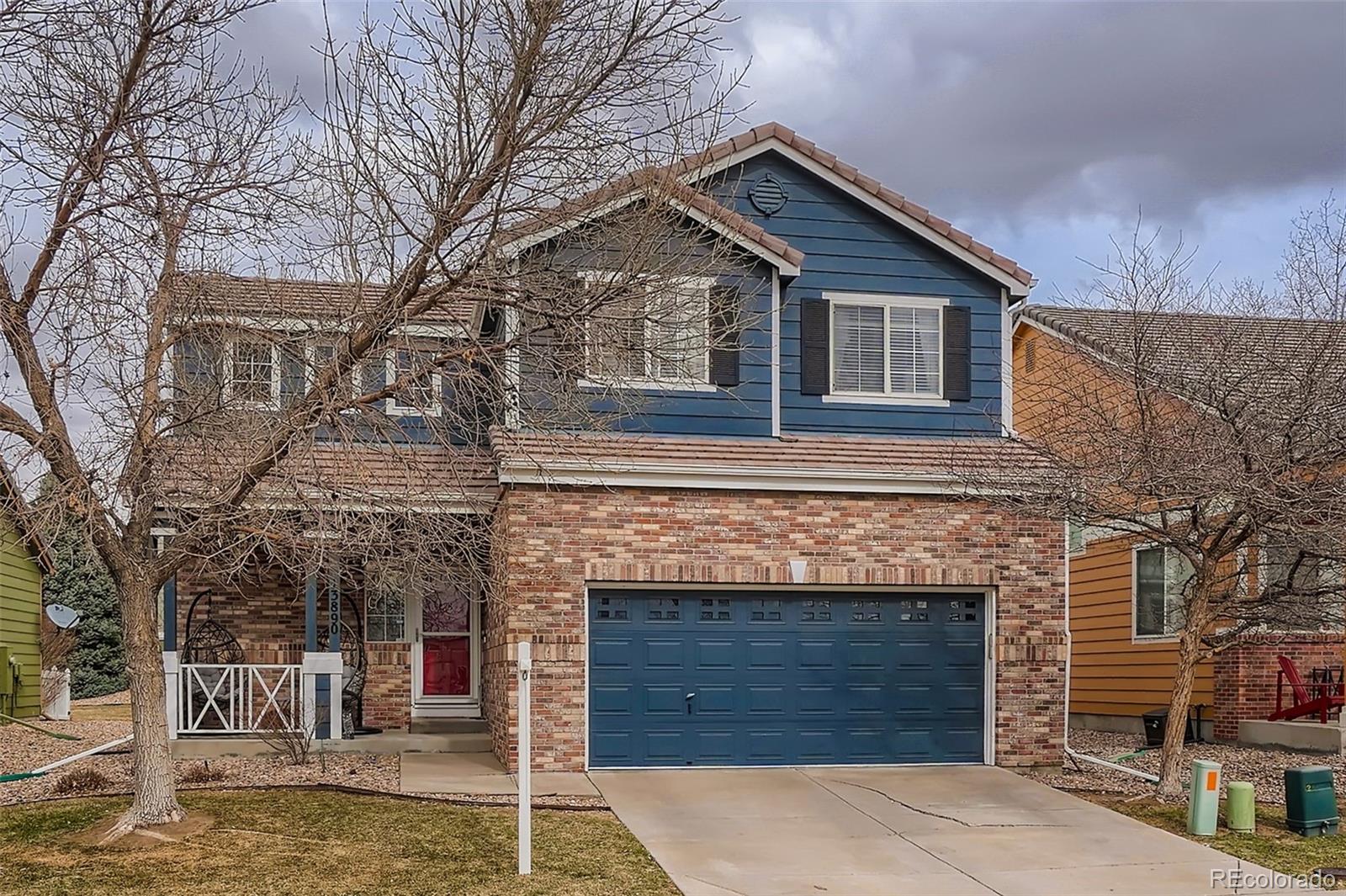a front view of a house with a garden and plants