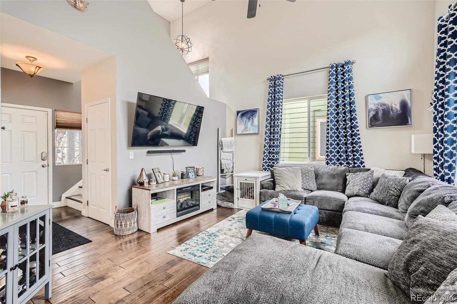 13890 Madison Street Thornton, CO 80602 - Photo 2 of 11 a living room with furniture and a flat screen tv
