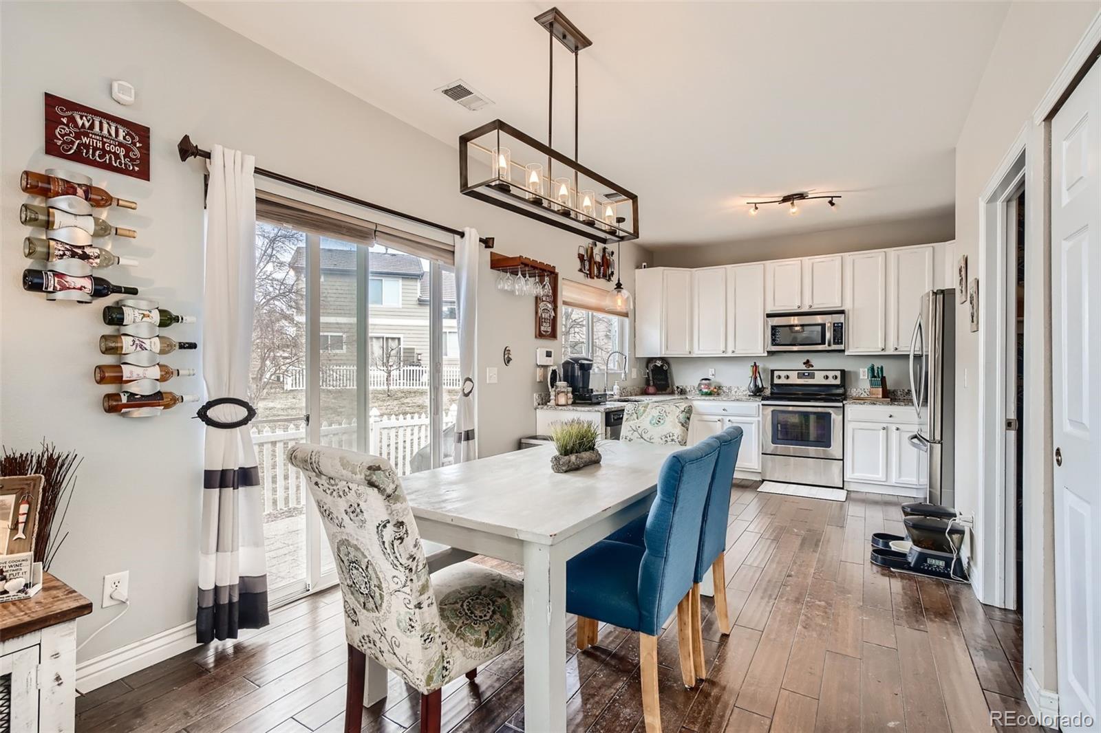 13890 Madison Street Thornton, CO 80602 - Photo 3 of 11 a view of a dining room with furniture window and wooden floor