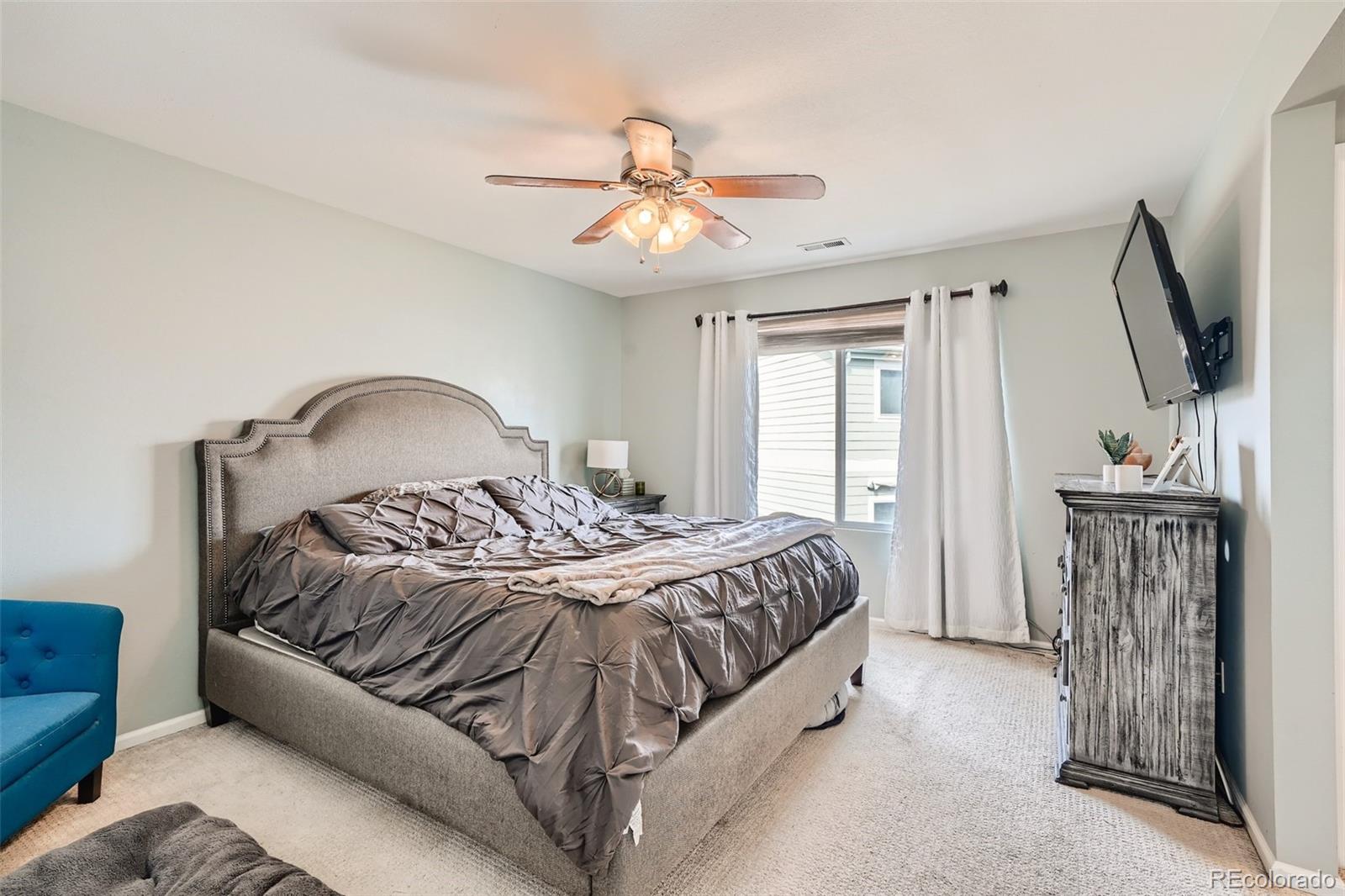 13890 Madison Street Thornton, CO 80602 - Photo 6 of 11 a bedroom with a bed and a flat screen tv