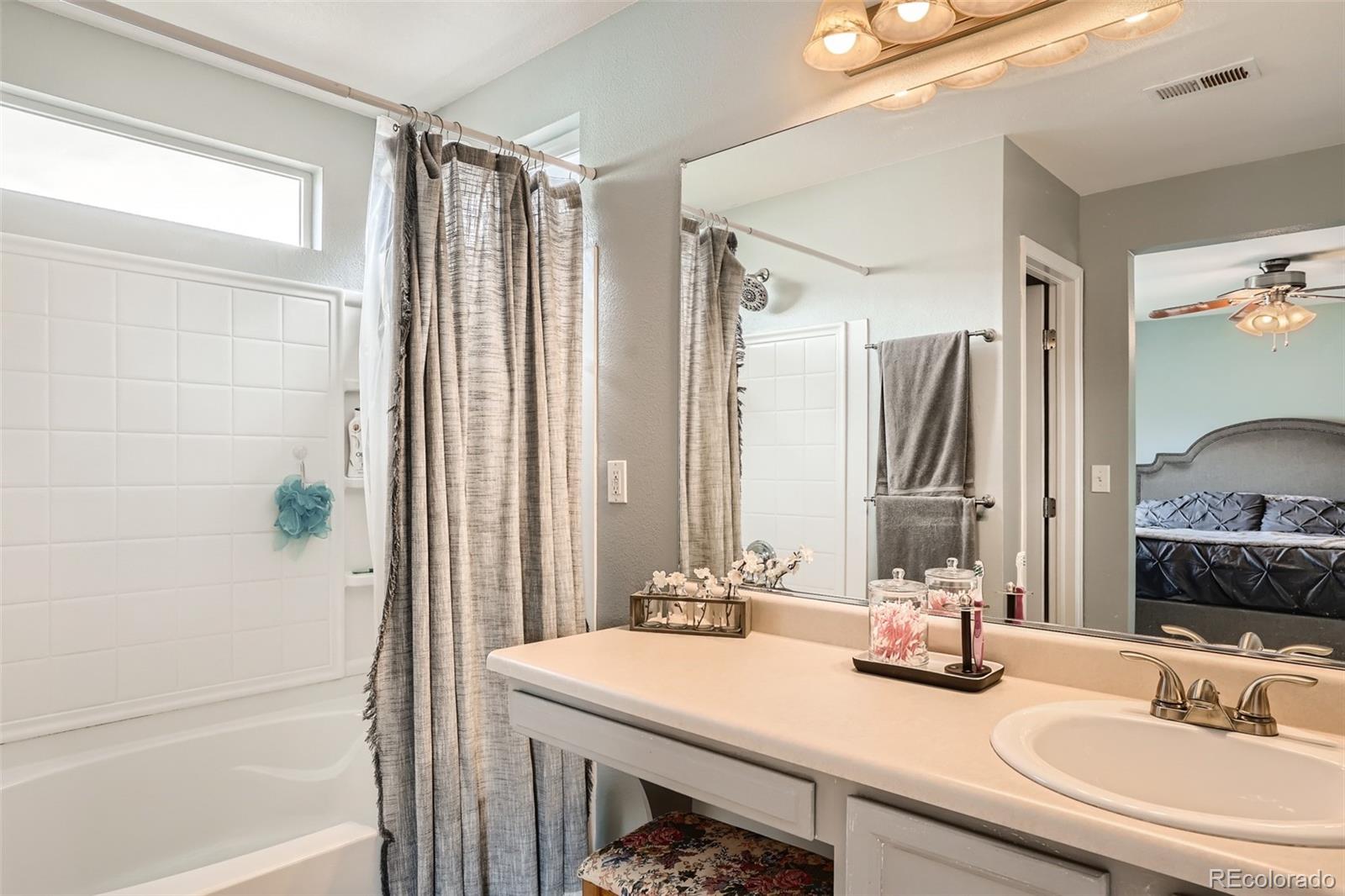 13890 Madison Street Thornton, CO 80602 - Photo 7 of 11 a bathroom with a sink and a mirror