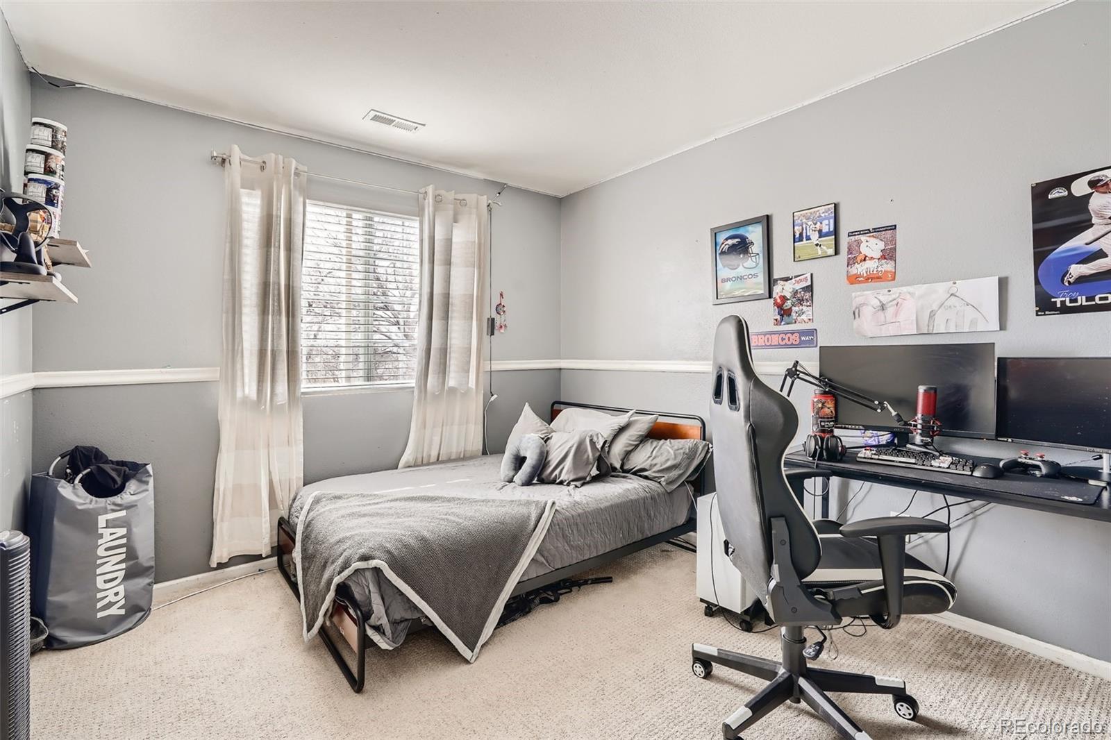 13890 Madison Street Thornton, CO 80602 - Photo 8 of 11 a bedroom with a bed and a desk