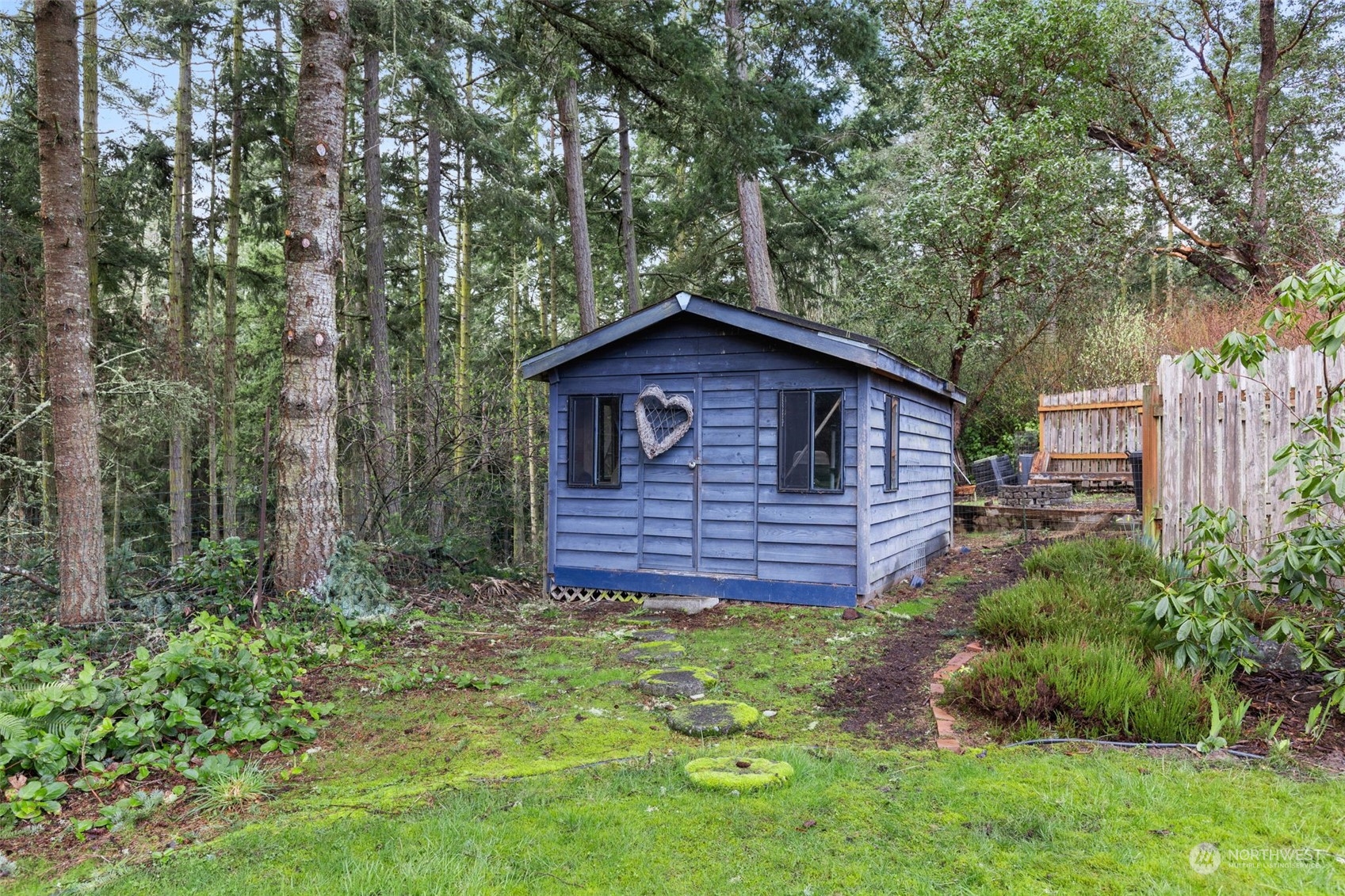 280 Cline Road Sequim, WA 98382 - Photo 27 of 32 a view of a house with a small yard plants and large tree