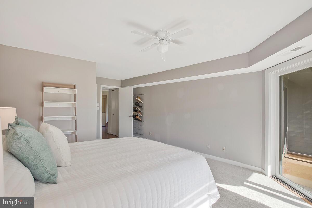 7002 Channel Village Court, Unit 101 Annapolis, MD 21403 - Photo 25 of 48 a bedroom with a bed and a large window