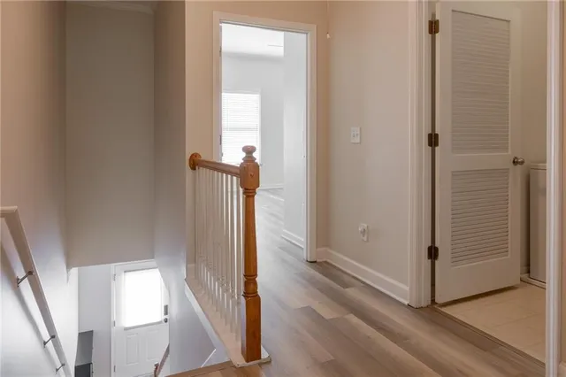 a view of a hallway with wooden floor and entryway