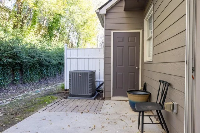 a view of backyard with a table and chairs and wooden fence