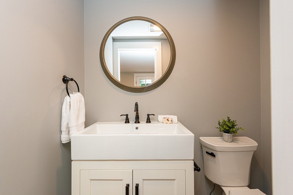 12 Moran Road Lynnfield, MA 01940 - Photo 18 of 42 a bathroom with a sink toilet and a mirror