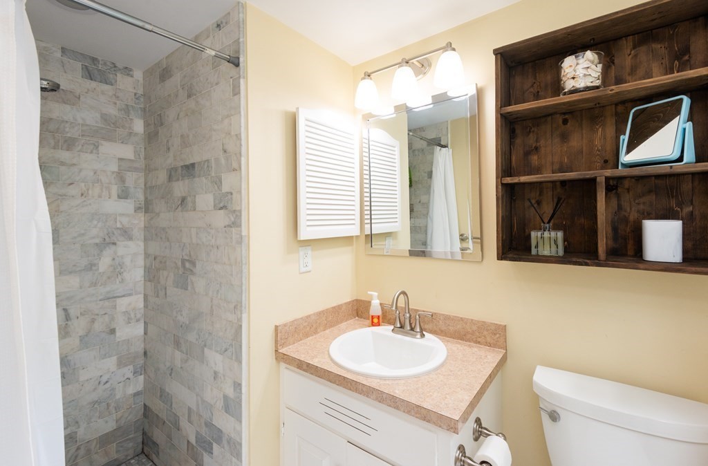 12 Moran Road Lynnfield, MA 01940 - Photo 29 of 42 a bathroom with a sink a toilet and shower