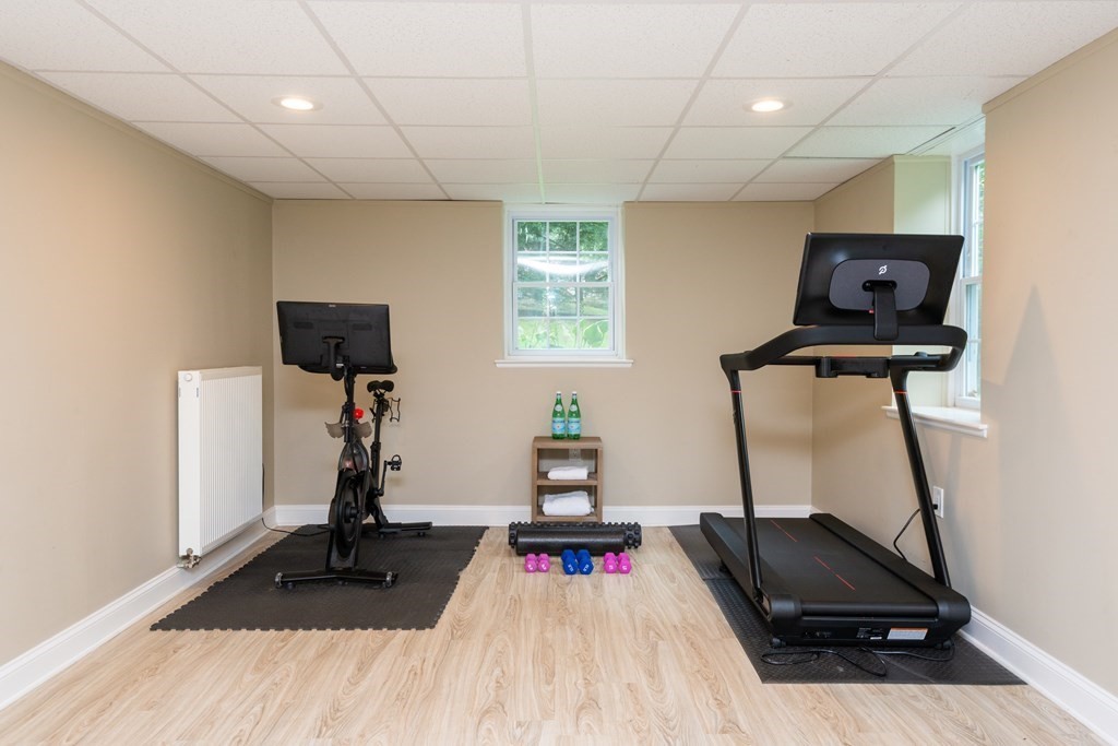 12 Moran Road Lynnfield, MA 01940 - Photo 38 of 42 a room with gym equipment and a flat screen tv