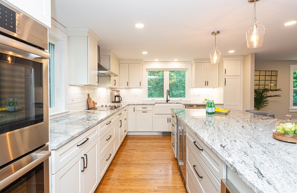 12 Moran Road Lynnfield, MA 01940 - Photo 7 of 42 a kitchen with a sink stove and wooden cabinets