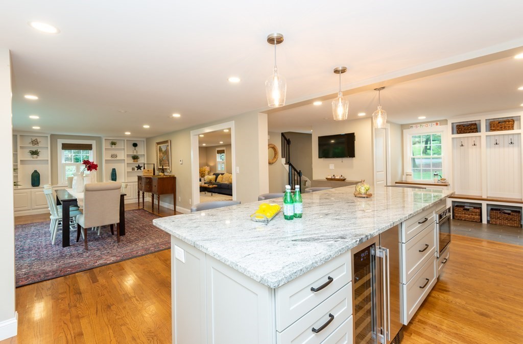 12 Moran Road Lynnfield, MA 01940 - Photo 8 of 42 a kitchen with stainless steel appliances granite countertop dining table and chairs in it