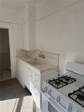 a white stove top oven sitting inside of a kitchen
