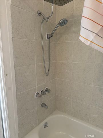 a bathroom with a shower and a bath tub