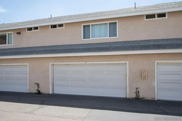 a view of a house with a small yard and plants